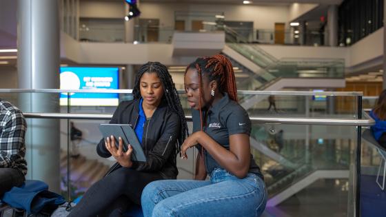 two students on an IPad